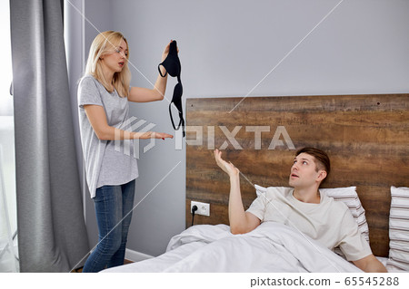 man tries to make excuses to his wife, explains that he did not cheat on her 65545288