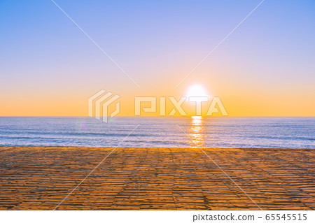 Beautiful tropical beach sea ocean with sunset or sunrise for travel vacation 65545515