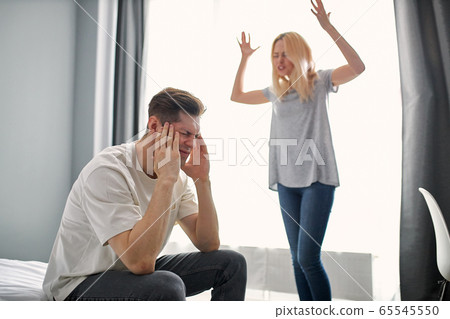 young caucasian man tired of screaming wife 65545550