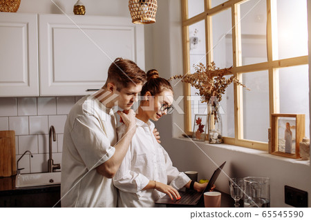 handsome man hugs her working wife 65545590