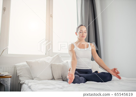 calm woman practice yoga at home calm woman practice yoga at home 65545619