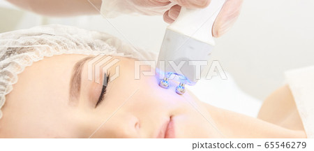 Dermatology skin care facial therapy. Medical spa anto wrinkles procedure. Woman face rejuvenation. Pretty girl. Rf cosmetician equipment 65546279