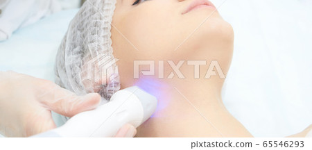 Dermatology skin care facial therapy. Medical spa anto wrinkles procedure. Woman face rejuvenation. Pretty girl. Rf cosmetician equipment. 65546293