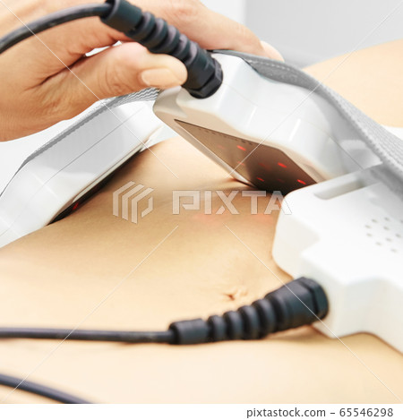 Laser lipo equipment. Cosmetic fat reduce treatment. Woman in medicine salon. Anti cellulite procedure Laser lipo equipment. Cosmetic fat reduce treatment. Woman in medicine salon. Anti cellulite procedure 65546298