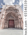 Arched entrance with sculptures and bas-reliefs to the Gothic temple 65546339