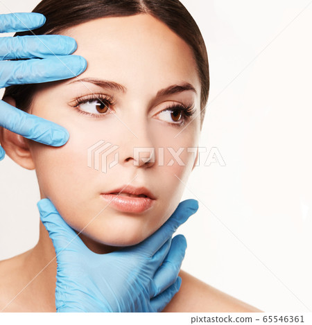 Facelift hydra treats. Esthetic skin care analysis. Doctor hands in gloves. 65546361