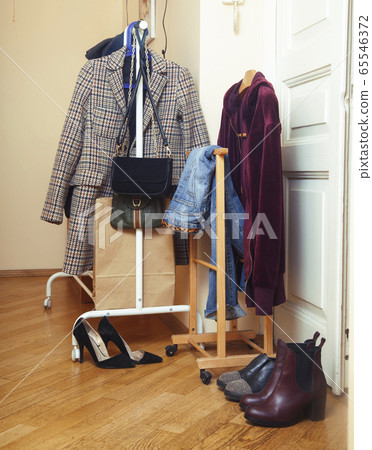 set of clothers and shoes in flat hanging on rail, modern girl casual wardrobe concept 65546372