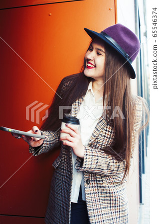 young pretty girl outside in city street with coffee happy smiling wearing hat, lifestyle fashion peopple concept 65546374