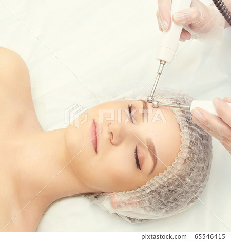 Dermatology skin care facial therapy. Medical spa anto wrinkles procedure. Woman face rejuvenation. Pretty girl. Rf cosmetician equipment Dermatology skin care facial therapy. Medical spa anto wrinkles procedure. Woman face rejuvenation. Pretty girl. Rf cosmetician equipment 65546415