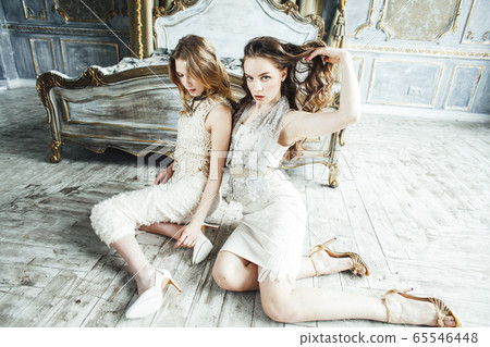 two pretty twin sister blond curly hairstyle girl in luxury house interior together, rich young people concept two pretty twin sister blond curly hairstyle girl in luxury house interior together, rich young people concept 65546448