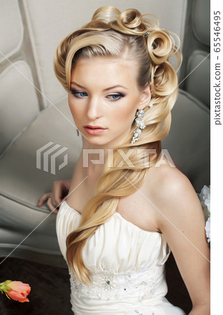 beauty young bride alone in luxury vintage interior with a lot of flowers, makeup and creative hairstyle 65546495