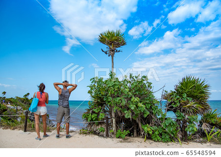 People watching the Caribbean Sea from El Castillo, the ruins of Tulum, Mexico People watching the Caribbean Sea from El Castillo, the ruins of Tulum, Mexico 65548594