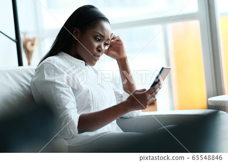Frustrated Black Woman Having Problems With Smartphone 65548846