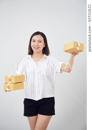 Woman holding package parcel box Woman holding package parcel box 65552672