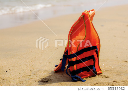 Life jackets on beach. 65552982