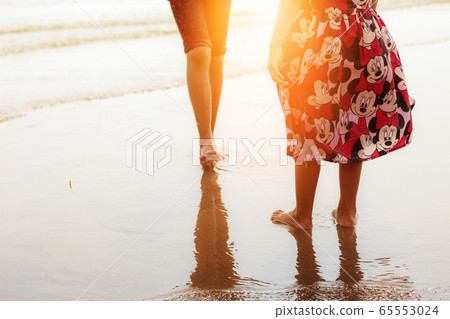 Girl on beach with sunlight. 65553024