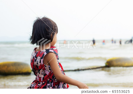 Girl on the beach. 65553025
