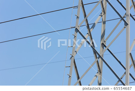 High-voltage electricity pylon against blue sky 65554687