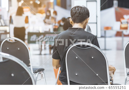 Back view of people order food and wait to take home inside of department store closed due to the coronavirus (Covid-19), Restaurants set chairs for social distancing to waiting for the food. Back view of people order food and wait to take home inside of department store closed due to the coronavirus (Covid-19), Restaurants set chairs for social distancing to waiting for the food. 65555251