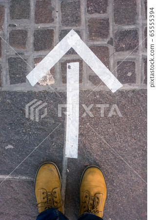 direction arrow in front of fashion store for the social distancing during the covid-19 pandemic 65555394