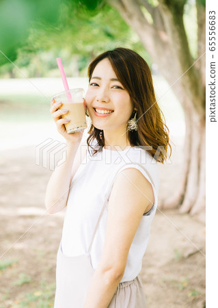 Woman drinking tapioca milk tea 65556683