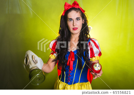 Woman holding hazardous radioactive apple. Nuclear and radiation measurement concept. Woman holding hazardous radioactive apple. Nuclear and radiation measurement concept. 65556821