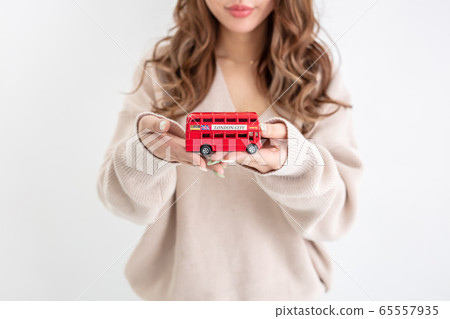 A woman with beautiful curly hair has a bus 65557935