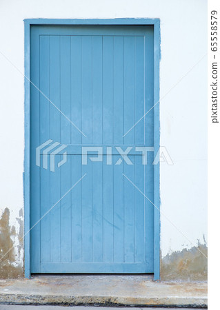 White wall and wooden door, background texture. White wall and wooden door, background texture. 65558579