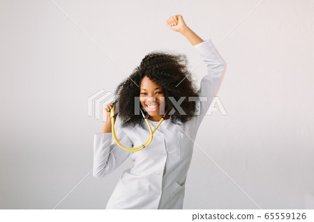 Beautiful female doctor with a stethoscope around her neck in hospital on white background 65559126