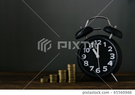Alarm clock and step of coins stacks on working Alarm clock and step of coins stacks on working 65560986