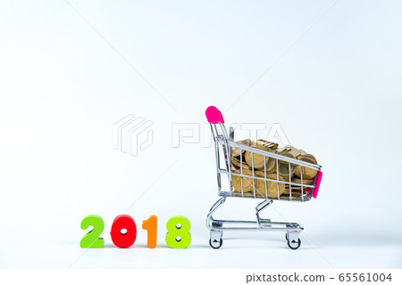 2018 wooden text and stacks of coins with shopping 65561004