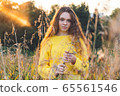 Cheerful smiling teenage girl of 14 years old with long curly red hair 65561546