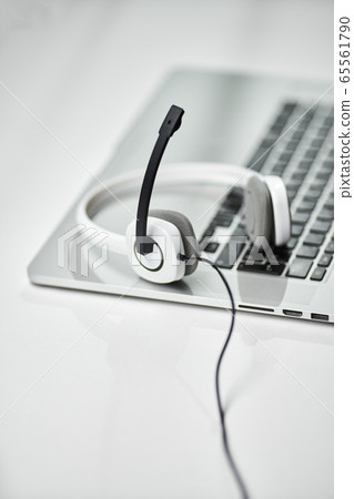 Top view of laptop, headphones with black microphone on table . Call center support Top view of laptop, headphones with black microphone on table . Call center support 65561790
