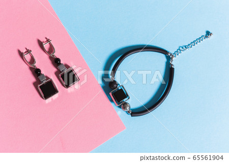 Top view of fashion jewelry and accessories on bright color background. Luxurious jewelry bijouterie and trendy concept. Top view of fashion jewelry and accessories on bright color background. Luxurious jewelry bijouterie and trendy concept. 65561904