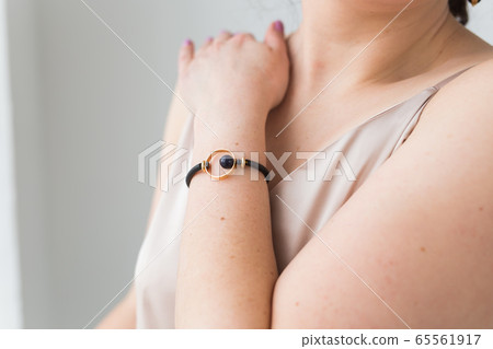 Close-up portrait of beautiful young woman with elegant hairstyle and luxurious jewelry and bijouterie. Close-up portrait of beautiful young woman with elegant hairstyle and luxurious jewelry and bijouterie. 65561917