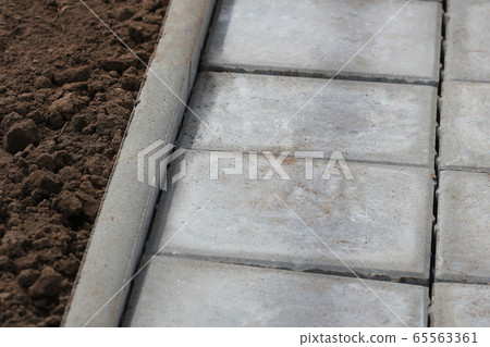 Concrete or cobble gray square pavement slabs or stones for sidewalk, road paving Concrete or cobble gray square pavement slabs or stones for sidewalk, road paving 65563361