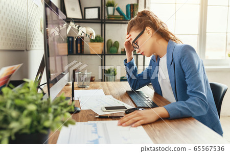 Young tired female employee resting in workplace 65567536