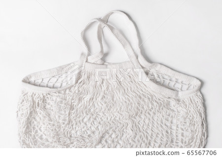 Empty reusable cotton shopping string bag on white 65567706