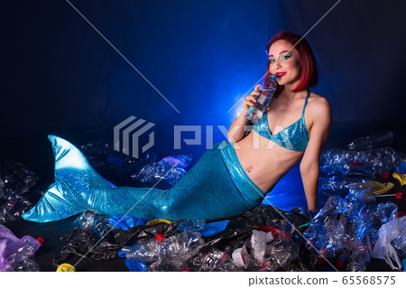 Fantasy stupid mermaid in deep ocean. Plastic trash and bottles pollution in ocean. Ecocatastrophe, garbage and plastic recycling concept. Fantasy stupid mermaid in deep ocean. Plastic trash and bottles pollution in ocean. Ecocatastrophe, garbage and plastic recycling concept. 65568575