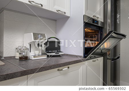 Electric appliances in minimalistic white kitchen interior Electric appliances in minimalistic white kitchen interior 65569302