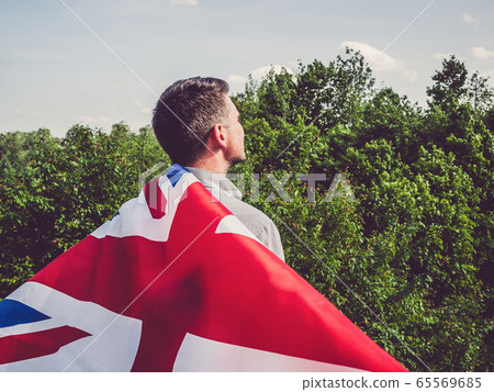 Attractive man holding Australian Flag. National Attractive man holding Australian Flag. National 65569685