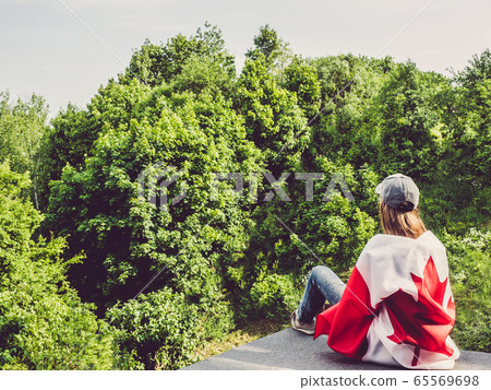 Cute woman holding Canadian Flag. National holiday Cute woman holding Canadian Flag. National holiday 65569698