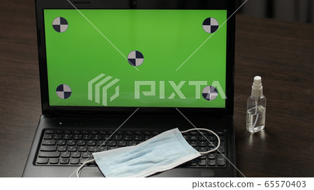Medical mask, sanitizer. Laptop green screen, chroma key. Coronavirus covid-19 65570403