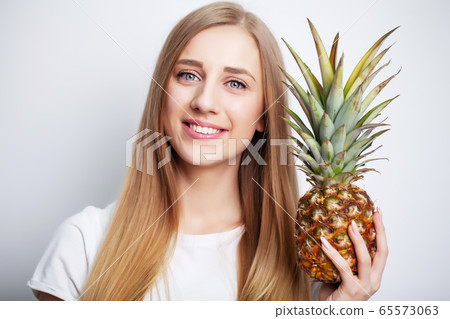 Natural cosmetics, beautiful woman face with pineapple. Natural cosmetics, beautiful woman face with pineapple. 65573063