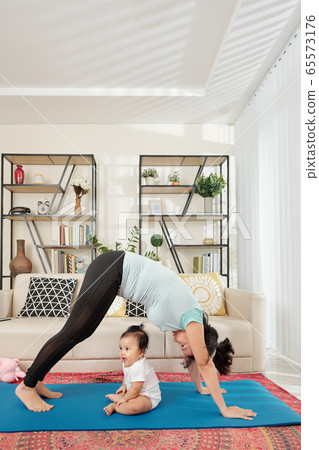 Young mother exercising at home Young mother exercising at home 65573176
