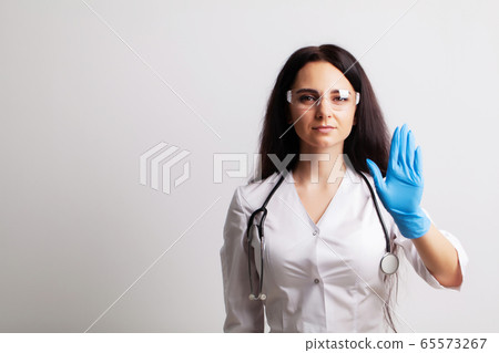 Doctor showing hand stop gesture, health safety concept Doctor showing hand stop gesture, health safety concept 65573267