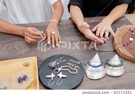 Women buying jewelry 65573381
