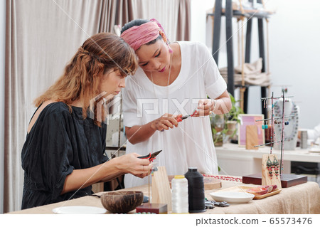 Women making jewelry 65573476