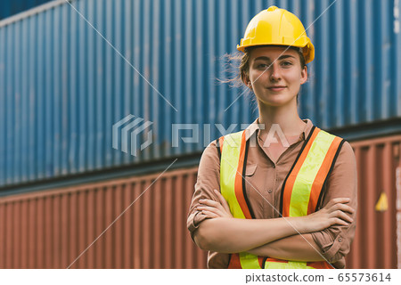 The logistics staff is standing in front of colorful containers at habour warehouse The logistics staff is standing in front of colorful containers at habour warehouse 65573614