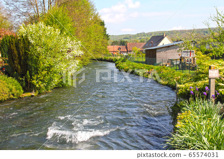 River in Normandy village 65574031